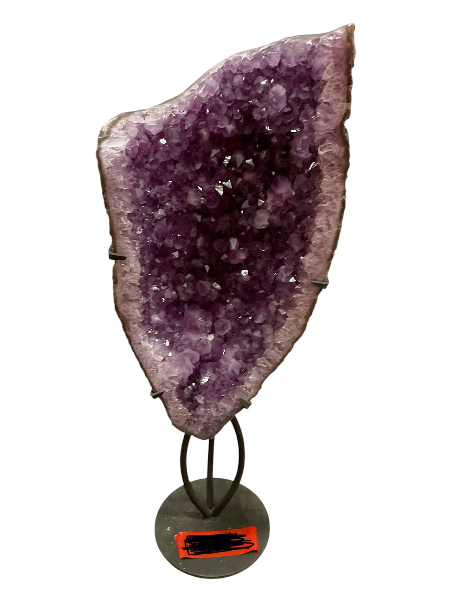 Large Amethyst Cathedral Geode on Metal Stand: A substantial natural amethyst cathedral geode displaying a deep cavity densely lined with sparkling purple quartz crystals. The crystalline interior ranges from pale lavender along the perimeter to r