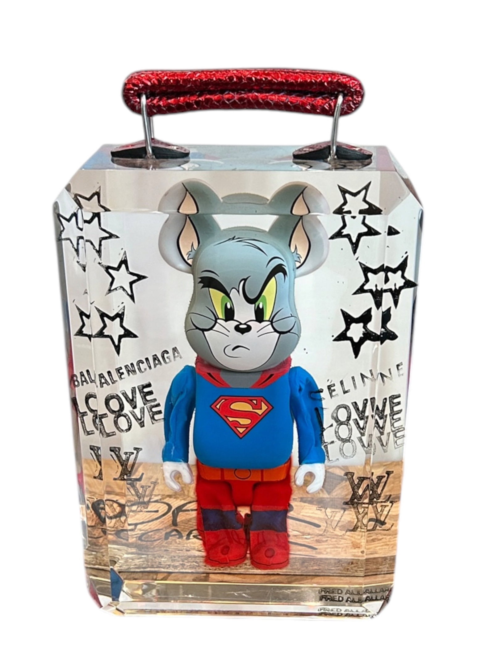 Super Cat Resin Handbag Sculpture by Fred Allard (French, B.1968): A contemporary clear resin handbag sculpture encapsulating a vinyl Bearbrick figure of Tom the Cat dressed in a Superman suit, complete with a red metallic snakeskin strap handle. The clear faceted re