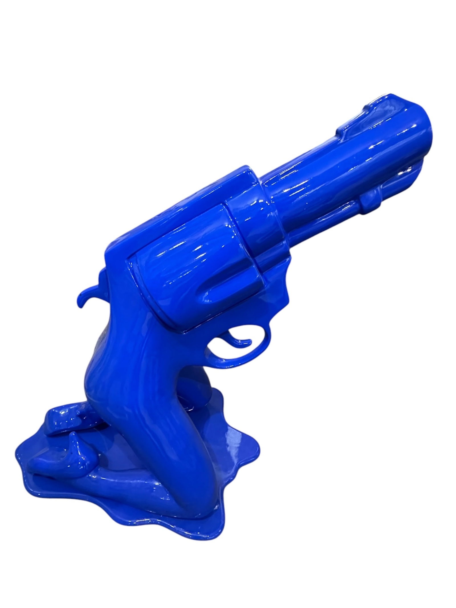Pop Art Kneeling Female Figure Revolver by Laura Curiel High-Gloss Resin Sculpture: A striking glossy cobalt blue Pop Art resin sculpture created by Mexican multimedia artist Laura Curiel, featuring a kneeling female lower body merging seamlessly into a large revolver frame. Executed