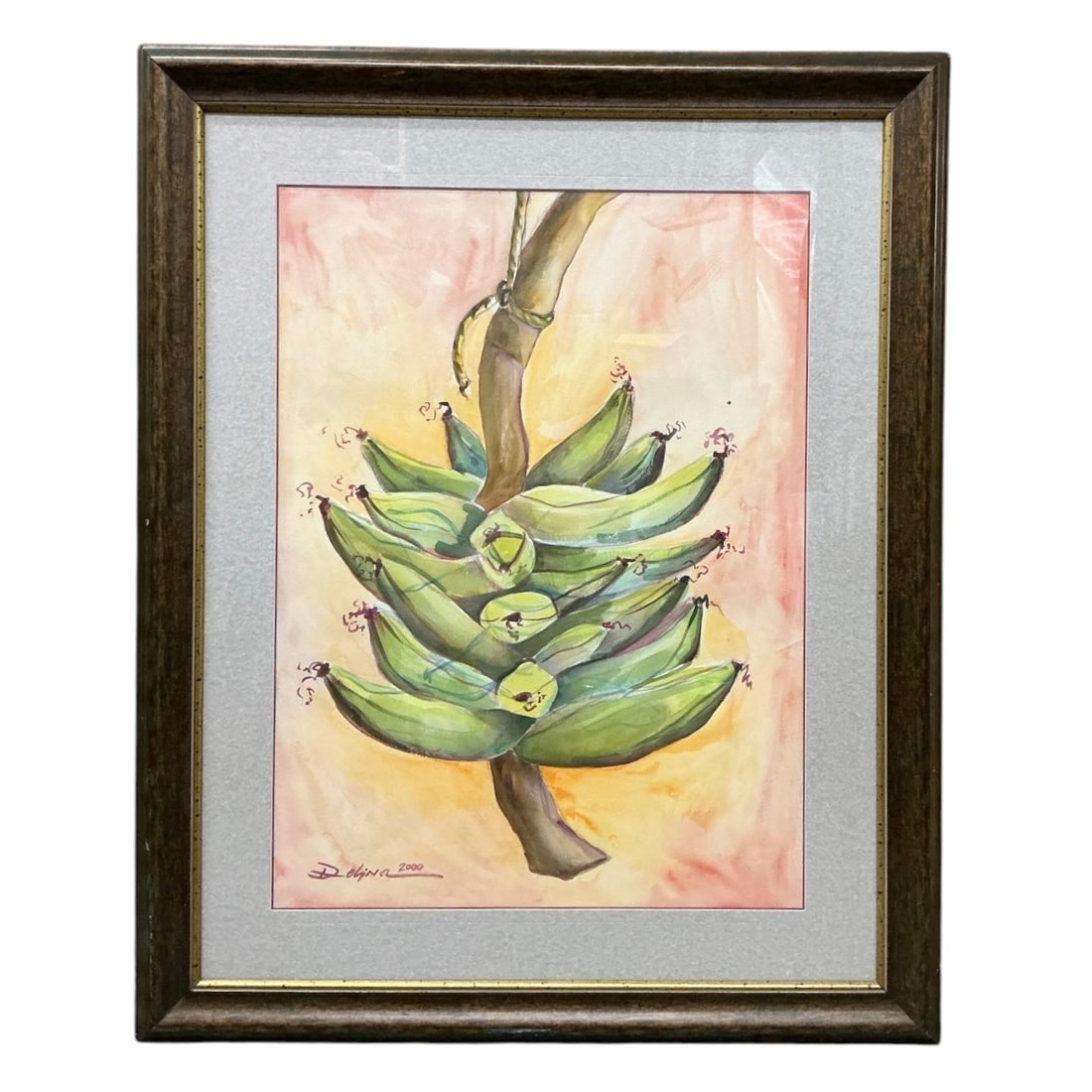 Hanging Bunch of Green Plantains by Delphina (Puerto Rican) Watercolor on Paper: Description Original watercolor painting on paper depicting a large stalk of green plantains hanging by a rope against a soft, wash background of peach and yellow