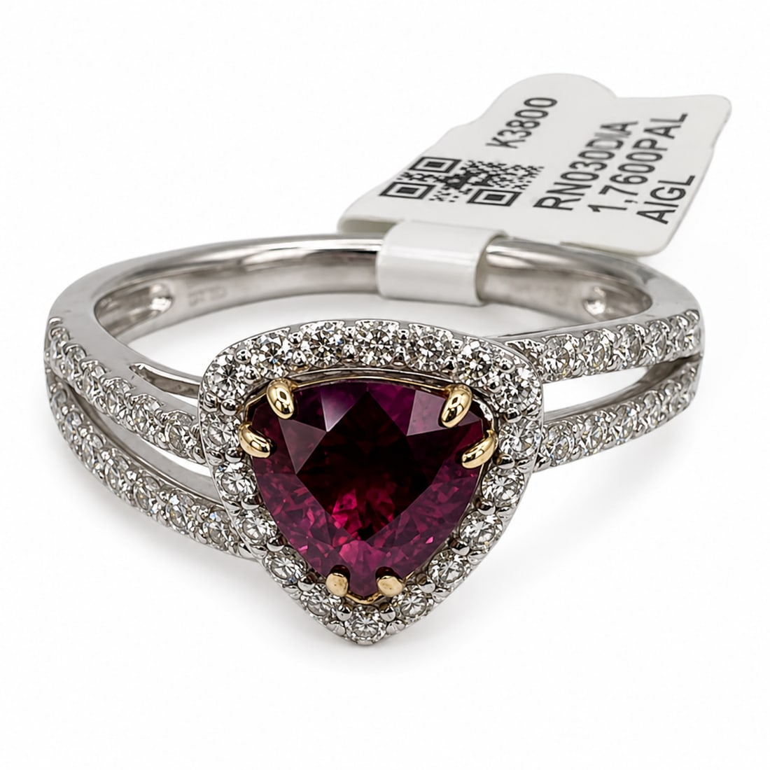 Platinum Kashmir Sapphire & Diamond Ring with GIA Report and Appraisal: Exceptional platinum ring centered with a trillion-cut Kashmir sapphire surrounded by a halo of round diamonds. The split-shank setting is further embellished with rows of diamond accents. Accompanied