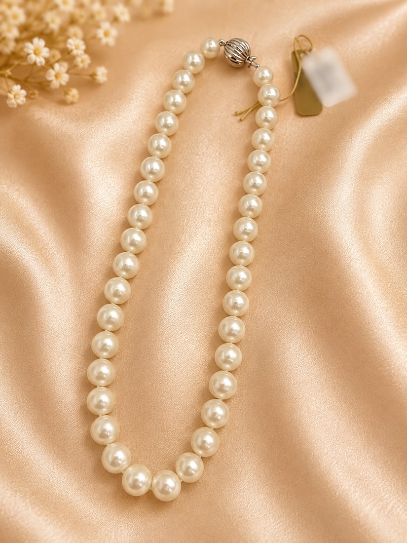 Cultured Pearl Necklace with Diamond Clasp and Appraisal: Elegant single-strand cultured pearl necklace featuring graduated creamy white pearls with a soft lustrous finish. Completed with a decorative diamond-accented clasp. Accompanied by a jewelry insuranc