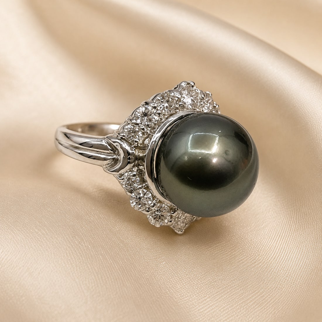 14K White Gold Tahitian Pearl & Diamond Ring with AIGL Appraisal: Elegant 14K white gold ring centered with a large dark Tahitian pearl displaying rich gray-green overtones, surrounded by a floral-style halo of round diamond accents. The sculpted shoulders and eleva