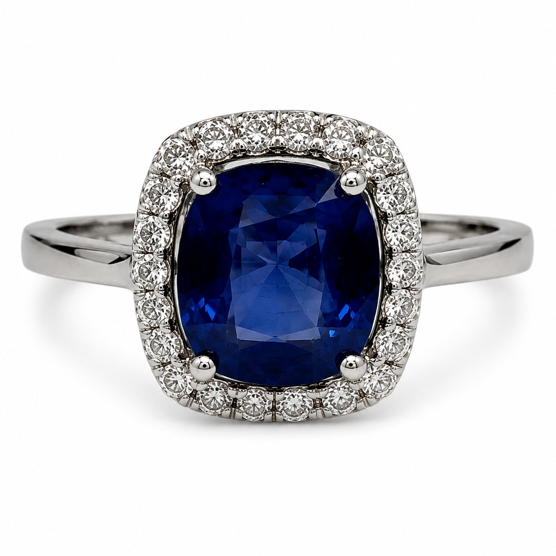 Platinum Ceylon Sapphire & Diamond Halo Ring with GIA Report and Appraisal: Elegant platinum ring centered with a cushion-cut natural blue sapphire surrounded by a halo of round brilliant-cut diamonds. The GIA report identifies the sapphire as natural corundum of Ceylon origi