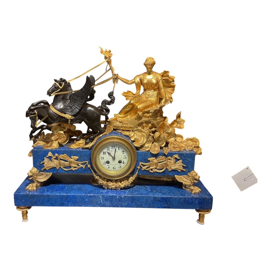CK098 - Gilt Bronze Figural Mantel Clock with Seated Lady in Chariot on Lapis Base: An exceptional figural mantel clock executed in t