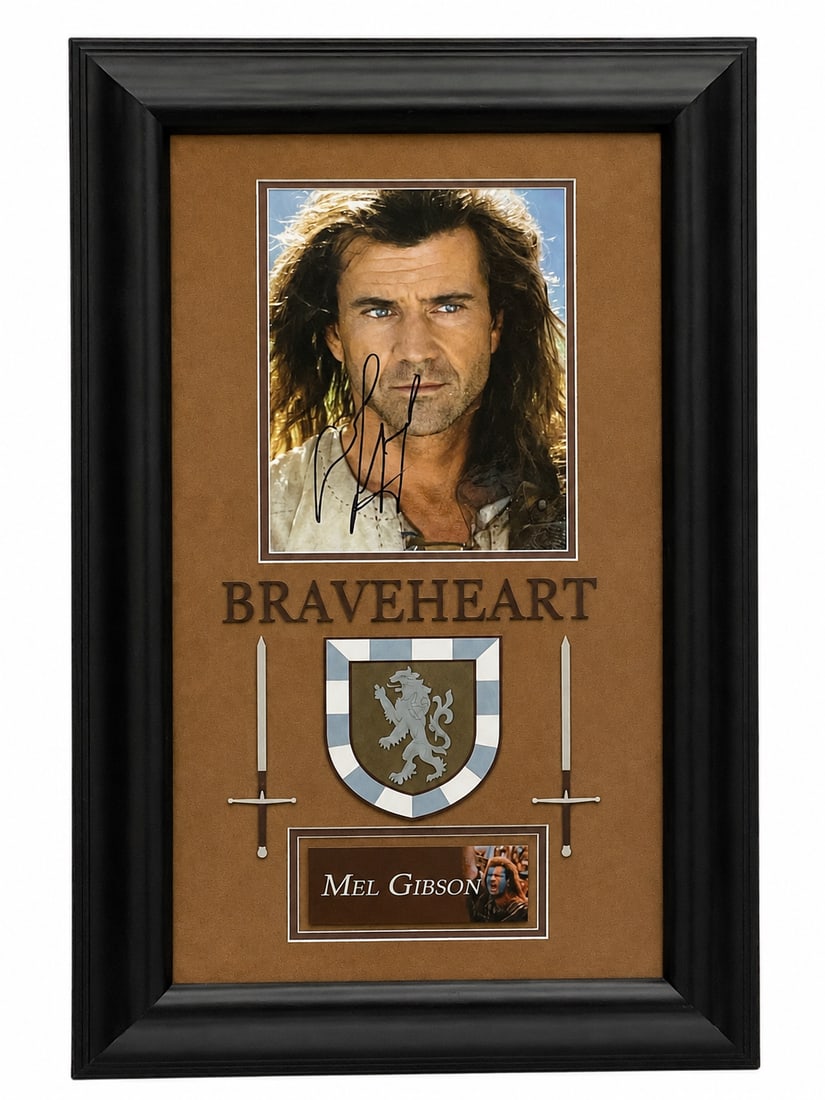 Mel Gibson Signed Braveheart Photo Display: Framed color photo of Mel Gibson as William Wallace in Braveheart, hand-signed by the actor. The display features decorative swords, a heraldic crest, and a nameplate. Includes certificate of authenti