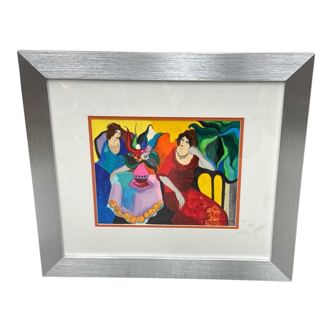 Limited Edition Itzchak Tarkay Lithograph Signed and Numbered 431/750: Description:Colorful limited edition figurative art print depicting two elegantly dressed women seated at a table with a floral arrangement, rendered in a bold decorative style with vibrant colors