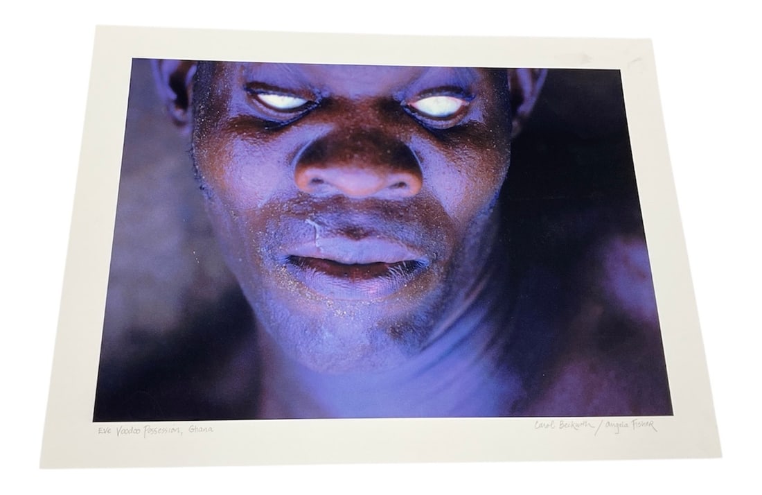 "Eve Voodoo Possession, Ghana" by Angela Fisher (Australia, B.1947) and Carol Beckwith (USA, B.1945): This color photograph captures a Himba woman in Namibia, characterized by the traditional application of otjize—a mixture of butterfat and ochre pigment—to her skin and hair. The portrait 
