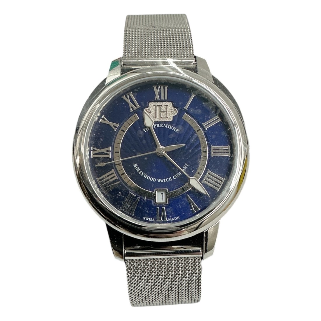 The Beverly by Hollywood Watch Company (USA, n.d.) Stainless Steel: A "The Beverly" model wristwatch by the Hollywood Watch Company. This timepiece features a stainless steel case and a stainless steel Milanese mesh bracelet, a dark blue dial with Roman nume