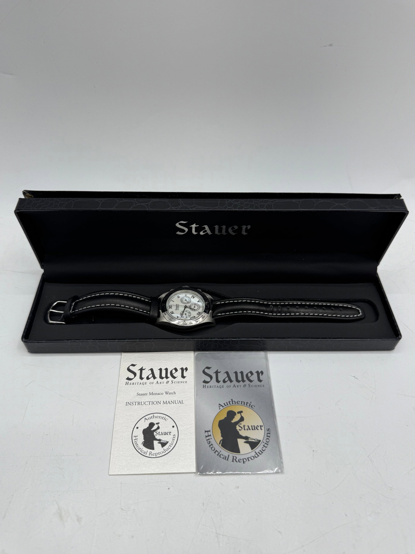 Stauer Wristwatch with Box: Stauer wristwatch with a black leather band and silver-tone face. Includes original box and paperwork.