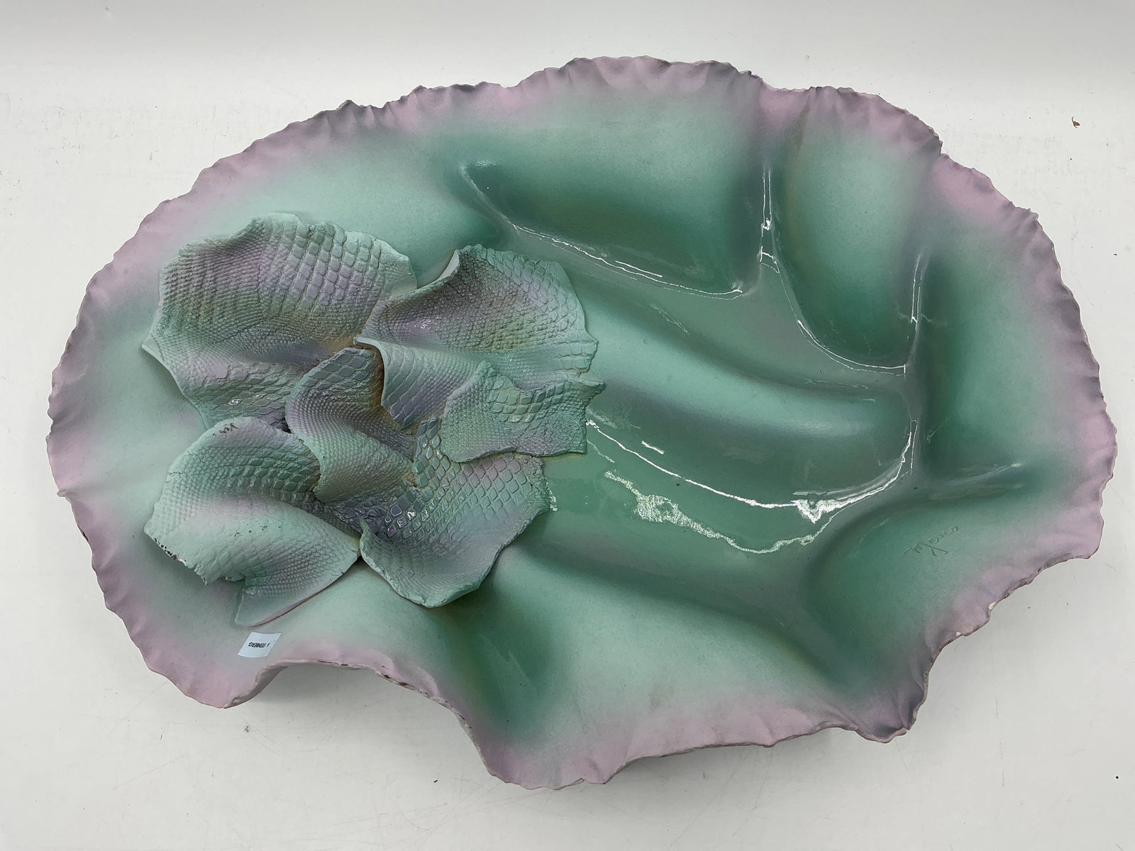 M Jesco Ceramic Floral Bowl: A Myco Mexico ceramic bowl featuring a stylized floral design in shades of green and lavender. Marked on the underside. Dimensions: H 4in x L 19in x W 14in.