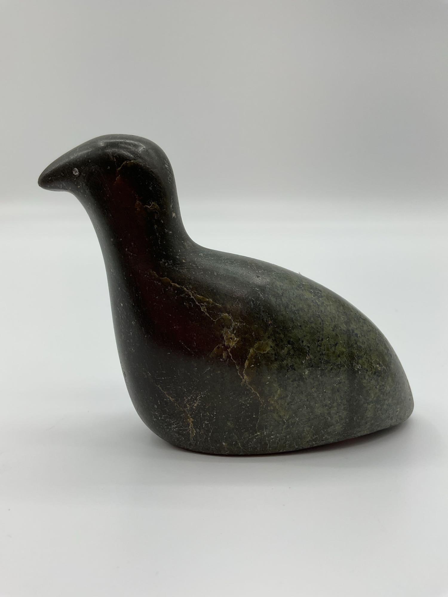 Hand-Carved Stone Bird Sculpture: This minimalist stone sculpture depicts a small bird in a resting pose with smooth, rounded features and subtle detailing. Carved from a greenish-black stone with natural veining, it has a polished fi