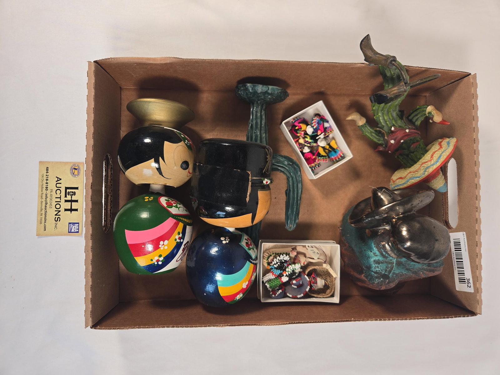 Lot of Figurines and Small Dolls: Pair of 6.5" Kokeshi Wedding Dolls. Cactus. 5" tall figure of a woman, Assortment of beaded and woven dolls, pins, and magnet. 7" tall sitting Cowboy & cactus