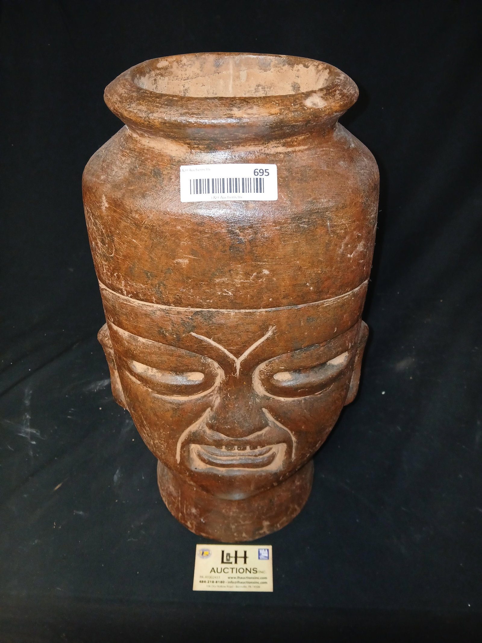 Mexican pottery vessel bearing a face (1 of 2)