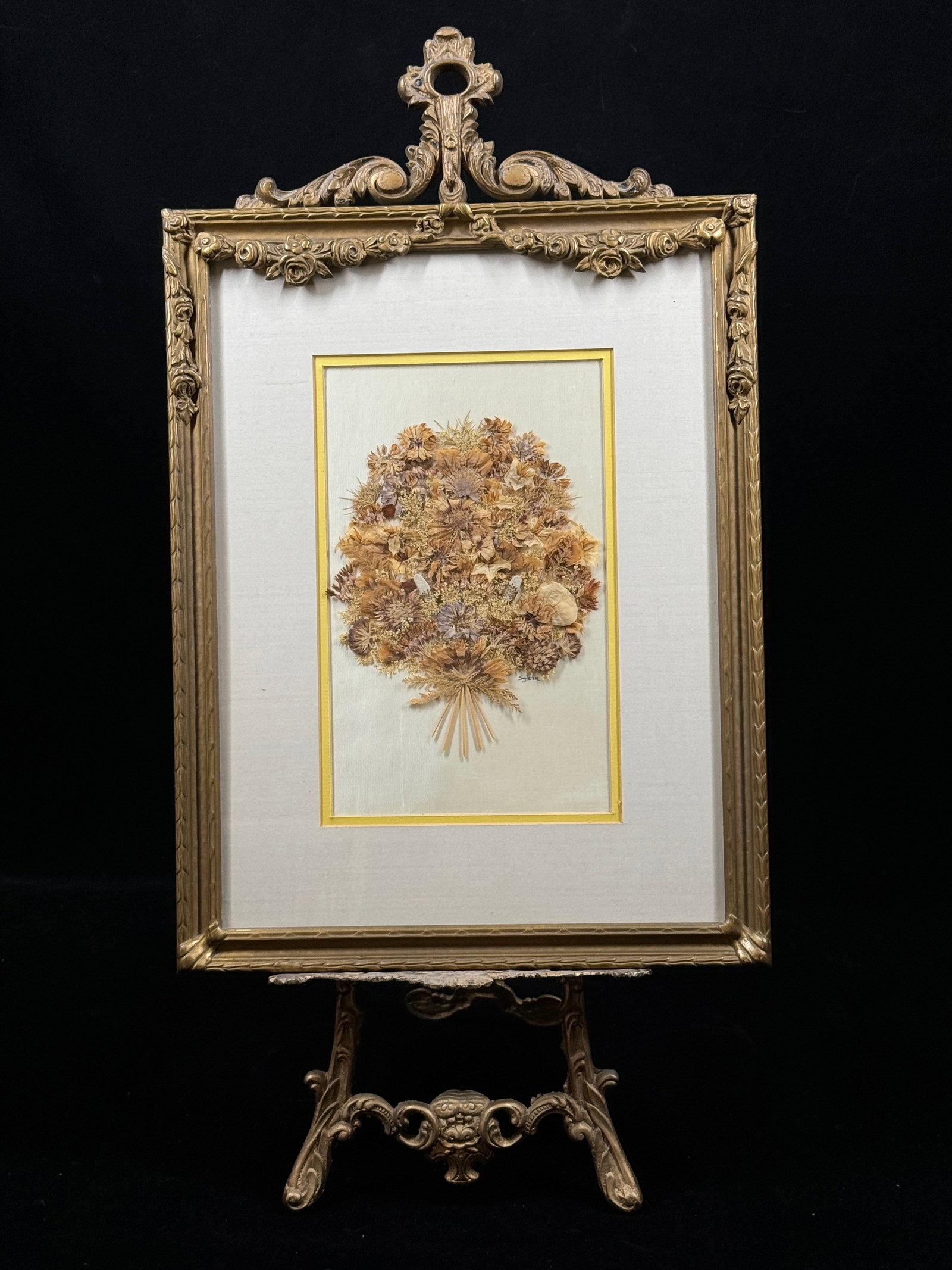 An Elaborately Framed and Mounted Arrangement Of Dried Kansas Wildflowers: An Elaborately Framed and Mounted Arrangement Of Dried Kansas Wildflowers by Sylvia Jackson 1989. The frame is French from the early 1920s. Frame is crowned with garlands of roses and an acanthus leaf