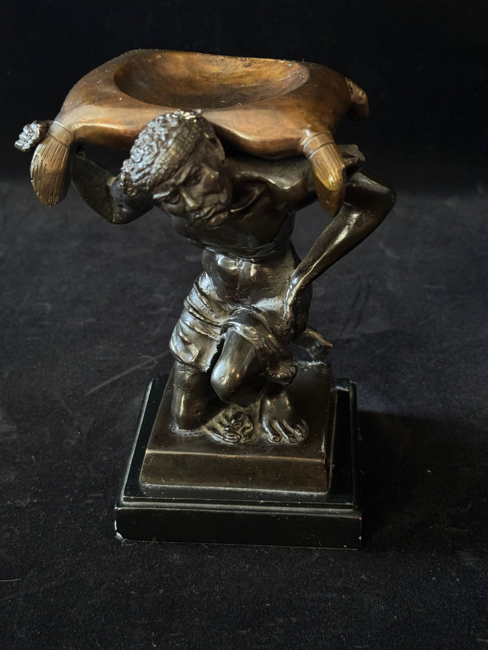 Cast Ring Holder of a Kneeling Figure with Brass Pillow: Cast Ring Holder of a Kneeling Figure with Brass Pillow MEDIUM: cast metal on a plaster base DIMENSIONS: 7” t CONDITION: good condition with one ding to base corner