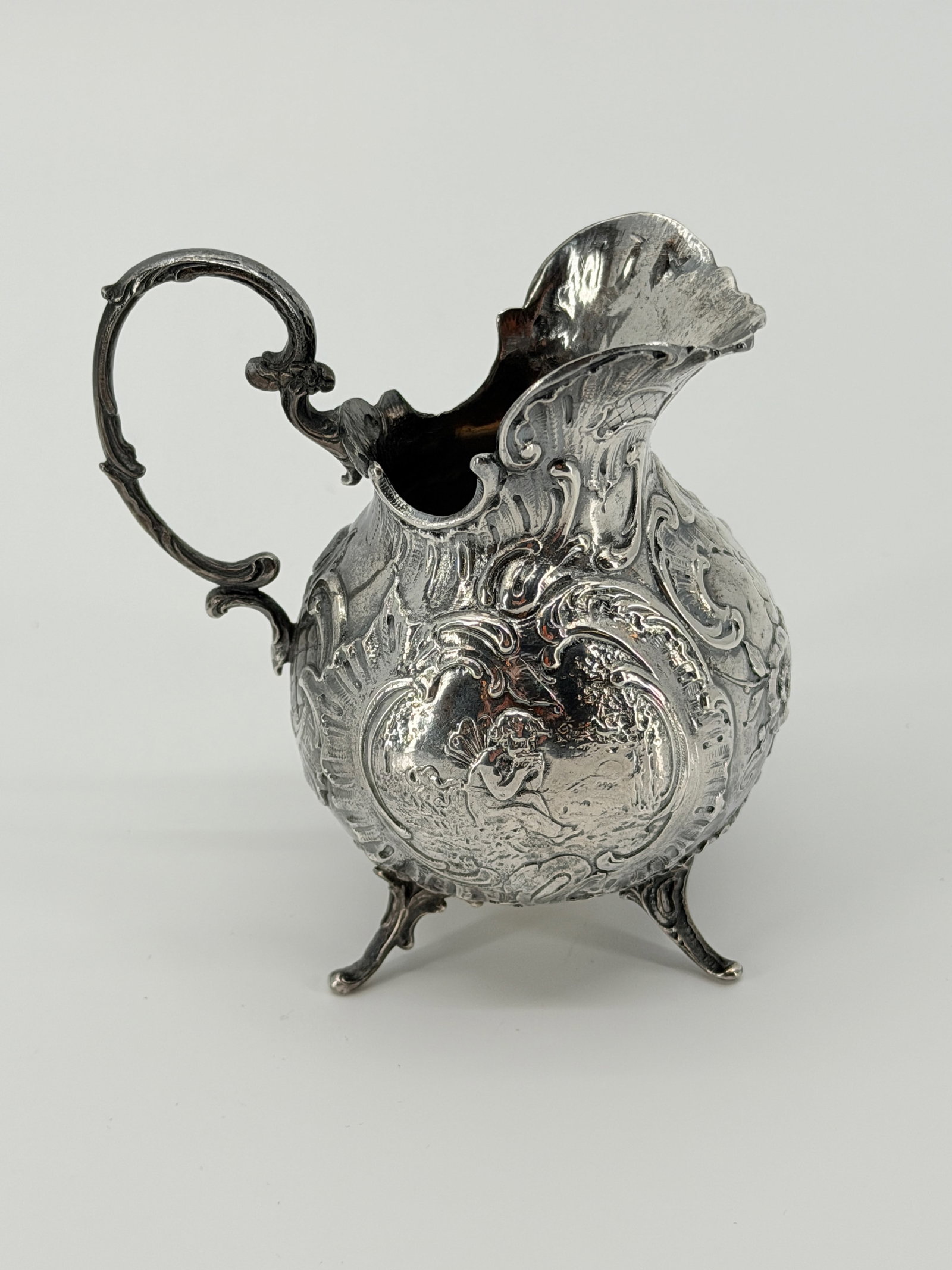 Ornate Antique Footed Sterling Repousse Decorated Creamer. (1 of 6)