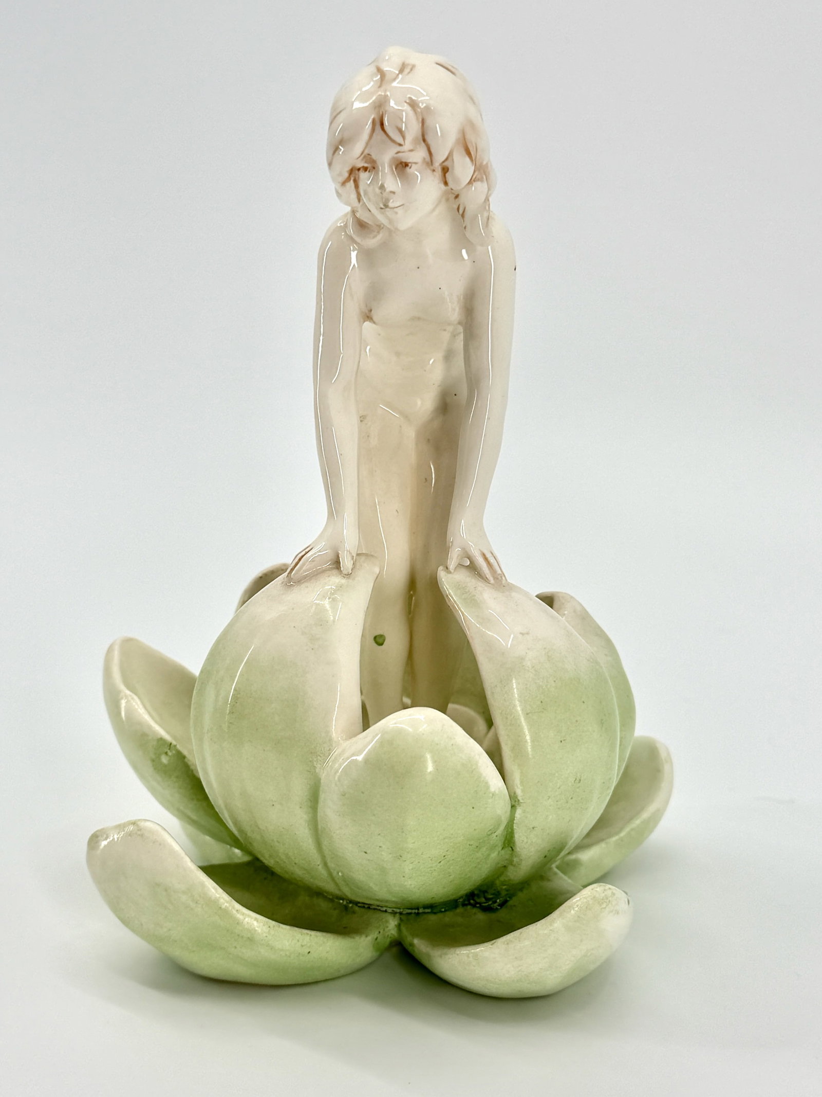 Czechoslovakian Naked Nymph Flower Frog: TITLE: A Czechoslovakian Naked Nymph Flower Frog ATTRIBUTION: Czechoslovakia # 1 3584 MEDIUM: Glazed Ceramic DIMENSIONS: 6.5 x 5 inches CIRCA: Early to Mid 20th Century. DESCRIPTION: The subject item