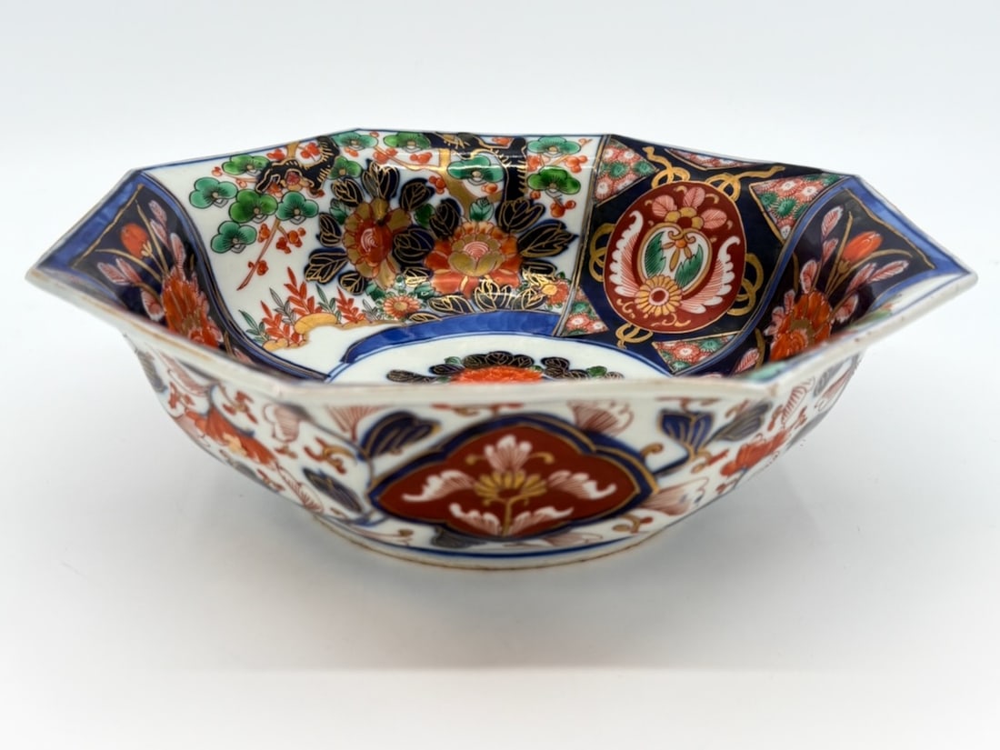 Large 19th C Japanese Imari Export Bowl with a Flaring Octagon Shape: TITLE: Large 19th C Japanese Imari Export Bowl with a Flaring Octagon Shape ATTRIBUTION: Japanese ExportMEDIUM:High Fire Hand Decorated PorcelainDIMENSIONS: 9.5 x 3 inchesCIRCA: 19th C.DESCRIPTION: Th
