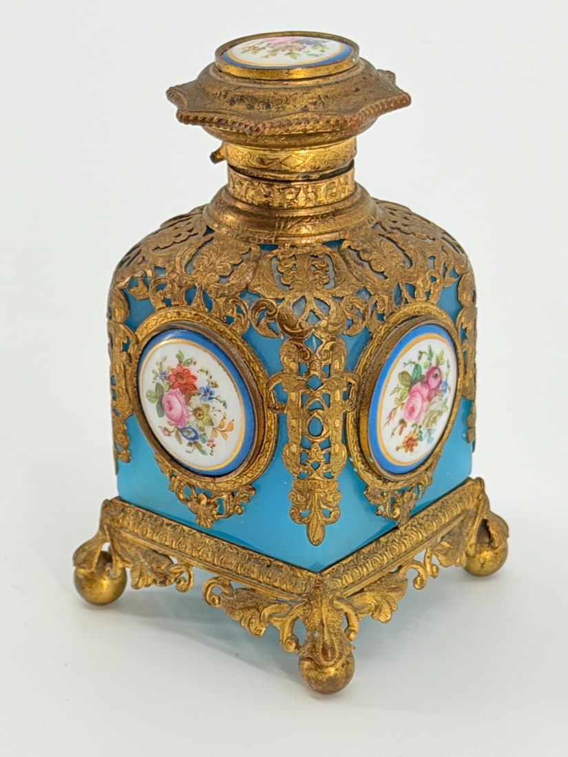 19th C Blue Opaline French Perfume Scent Bottle: TITLE: 19th C Blue Opaline French Perfume Scent BottleATTRIBUTION: FrenchDIMENSIONS: 4.5” TCIRCA: 19th CDESCRIPTION: The cube-shaped glass is adorned with finely worked gilt metal mountings. The