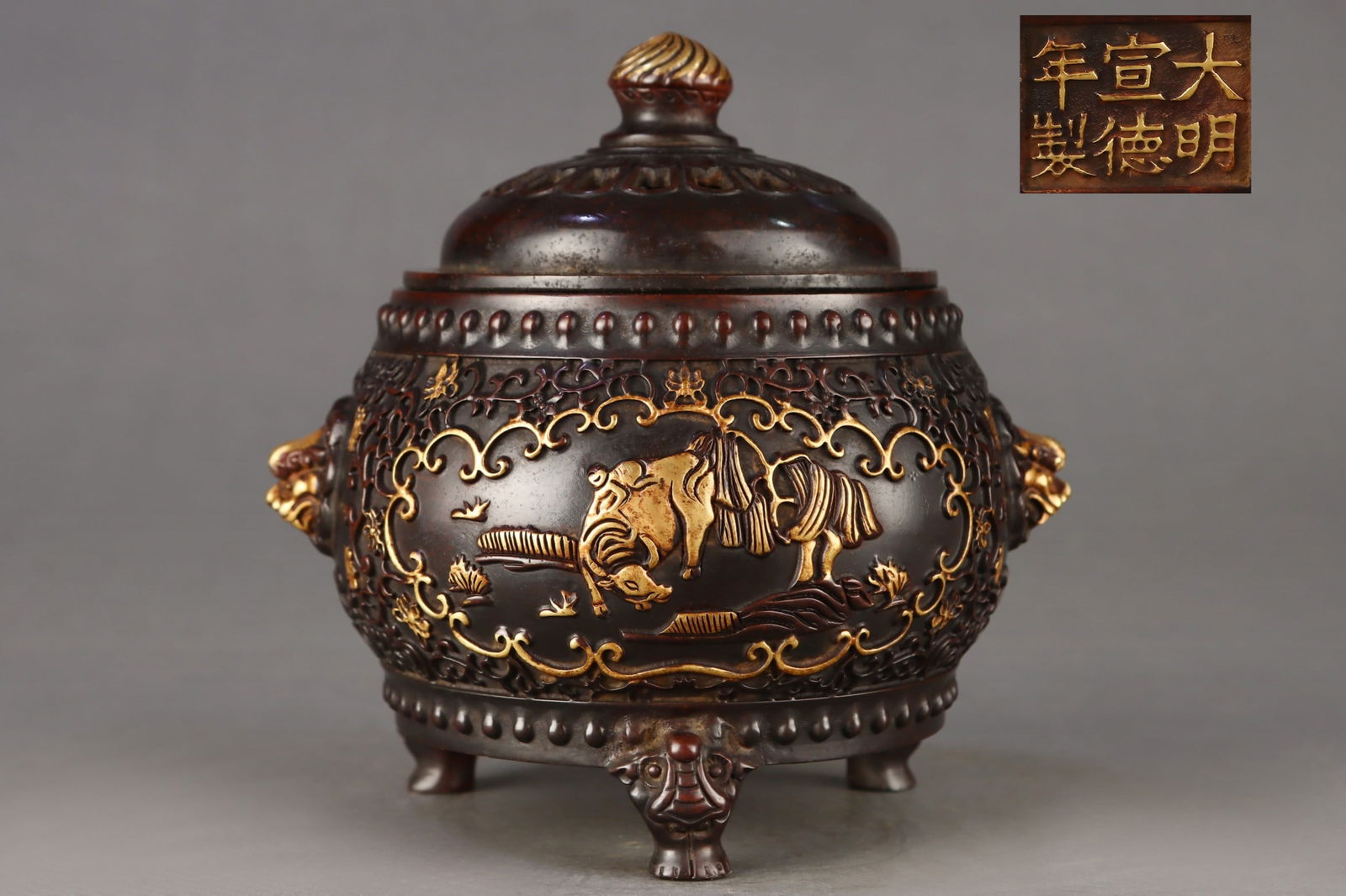 Gilt Bronze Drum-Shaped Incense Burner with Shepherd Boy Riding an Ox: A finely cast, gilt bronze drum-shaped incense burner with a shepherd boy riding an ox, dating from the Ming Dynasty. Dimensions: Height 17.5cm, Mouth diameter 12.3cm, Belly diameter 16cm, Ear spacing