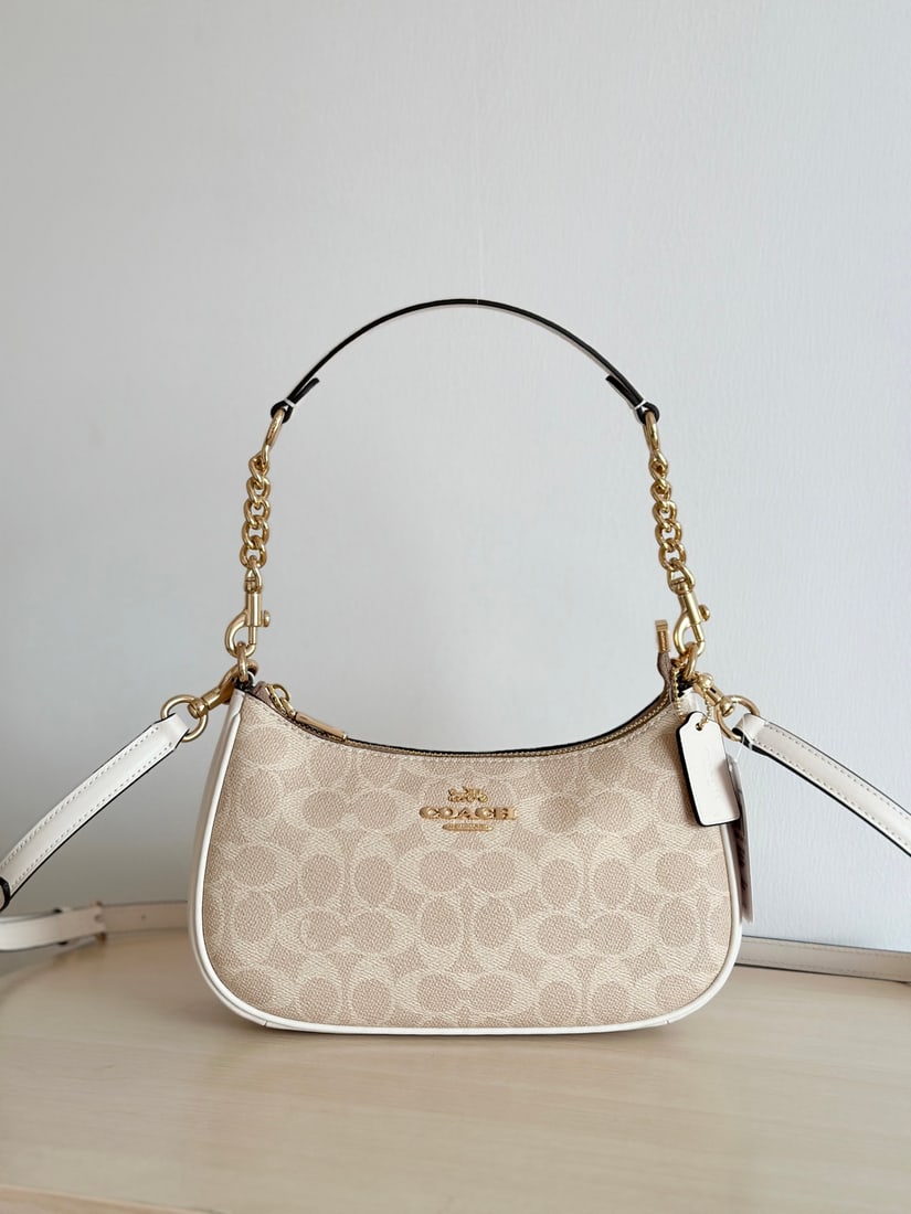 Coach: This Coach TERI classic logo shoulder bag features PVC trim and leather accents, making it a stylish choice for shoulder, crossbody, underarm, or handbag. Made of durable cowhide, it's larger than a m
