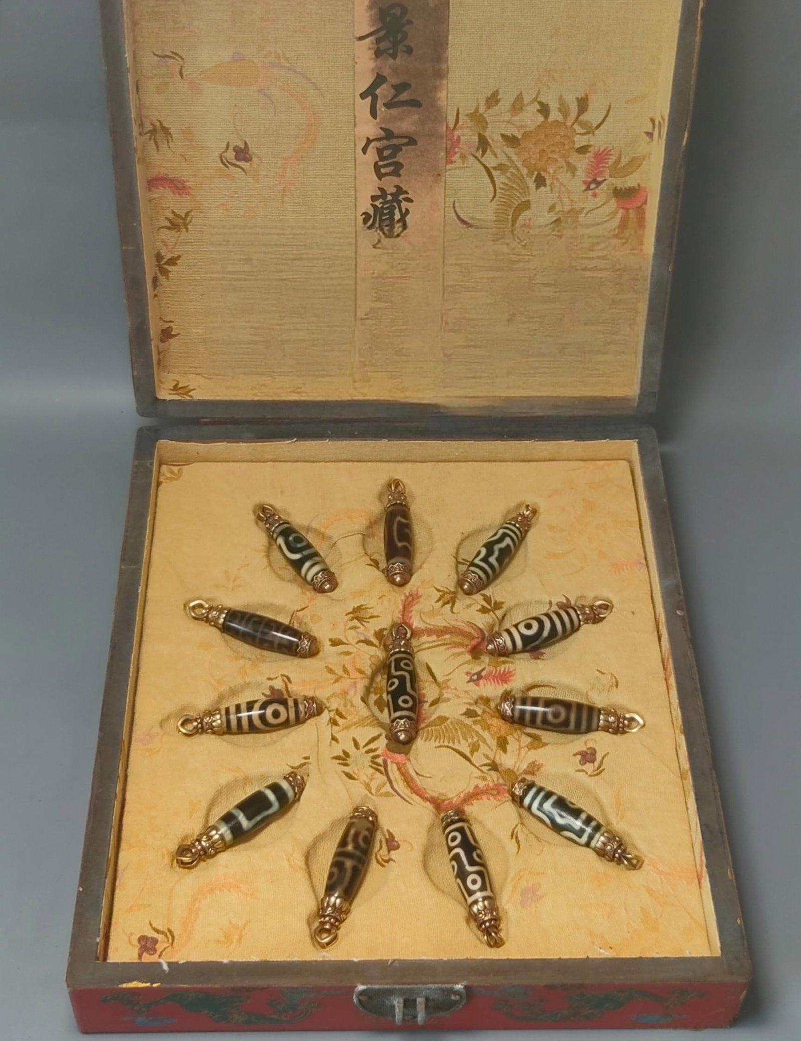 Dzi beads and agate in a nanmu wood box with gold trim (1 of 9)