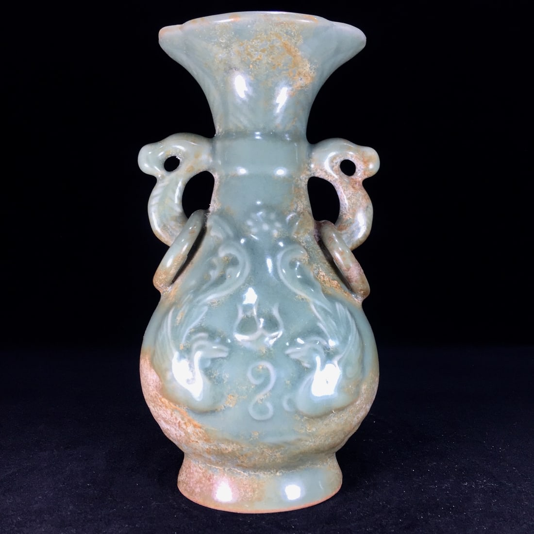 A Song Dynasty Longquan porcelain vase with double-eared handles, exhibiting clear water stains from (1 of 9)