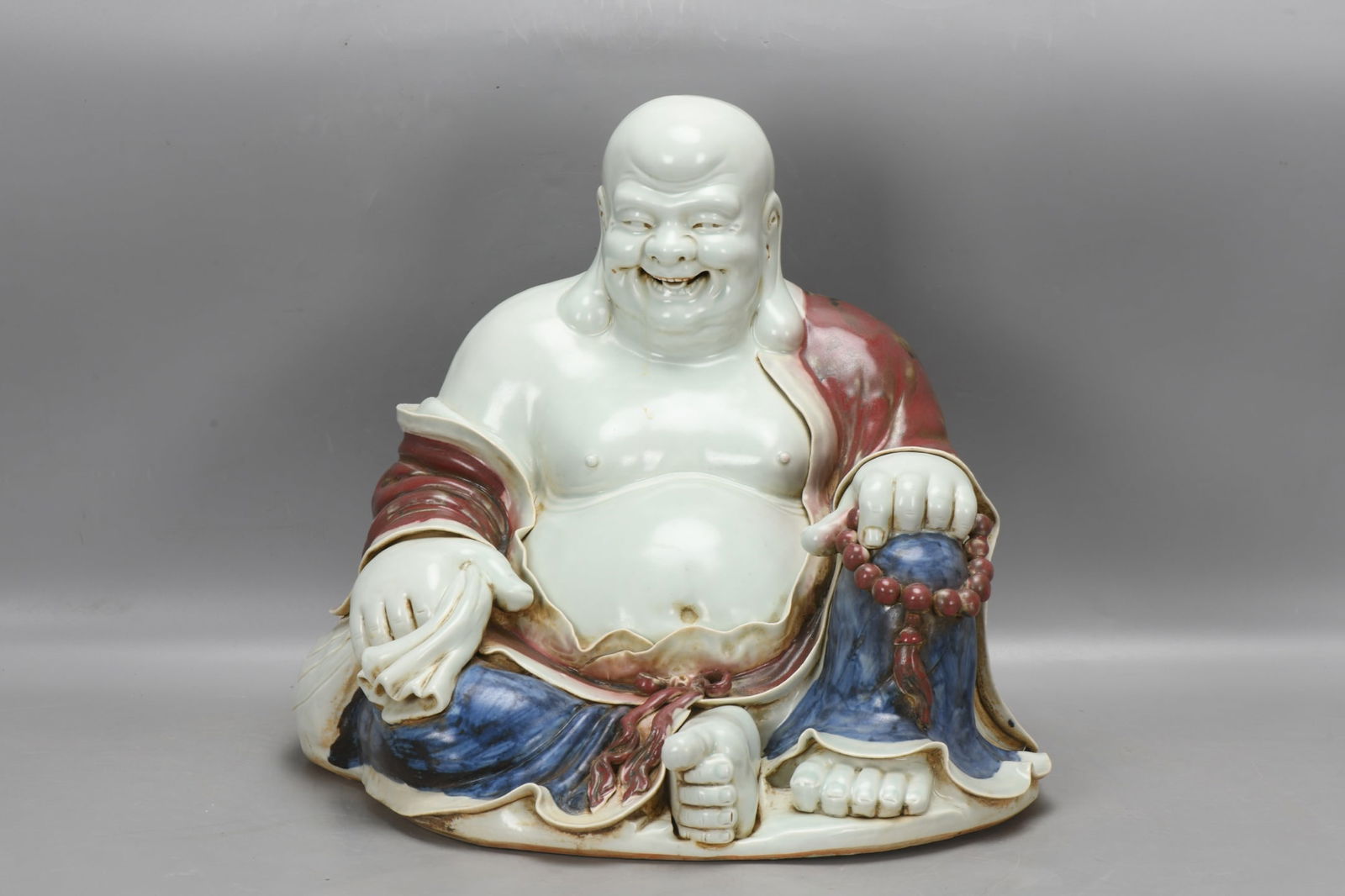 A Yuan Dynasty blue and white underglaze red laughing Buddha statue (1 of 9)