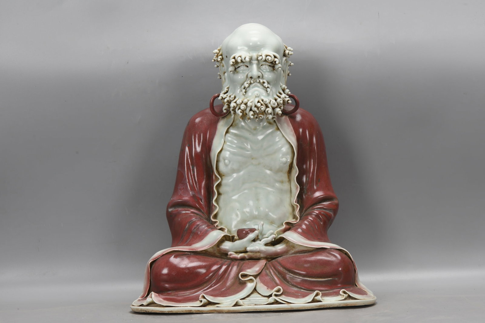 Yuan Dynasty, a Bodhidharma statue with sweet white glaze and underglaze red. (1 of 9)