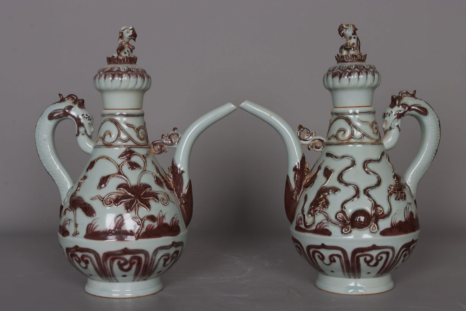 A pair of Yuan Dynasty underglaze red carved double lions playing with a ball, cranes and flowers: It measures 31 cm in height, 3 cm in mouth diameter, 24 cm in belly diameter, and 9 cm in base diameter. Provenance:Private collection from a professor in University of Cambridge. Our cooperative logi
