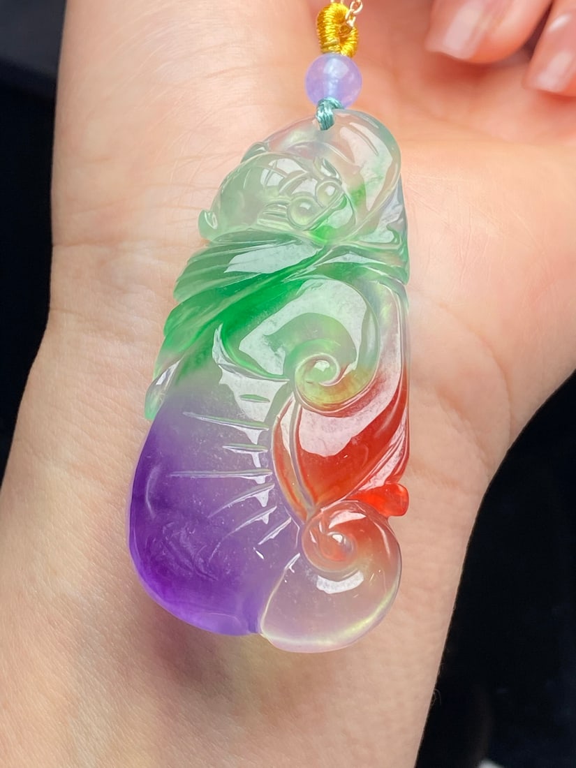 Jadeite Icy Tricolor "Ruyi" Pendant: This jadeite pendant, made of icy jadeite with three colors, is translucent and lustrous, with a fine texture, exquisite carving, and a full, thick, and flawless appearance. Provenance:Private collect