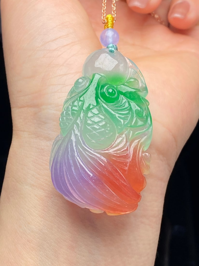 Jadeite Icy Tricolor "Goldfish" Pendant: This jadeite pendant, made of icy jadeite with three colors, features a translucent and lustrous texture, fine material, exquisite carving, a substantial and full shape, and is flawless with no cracks