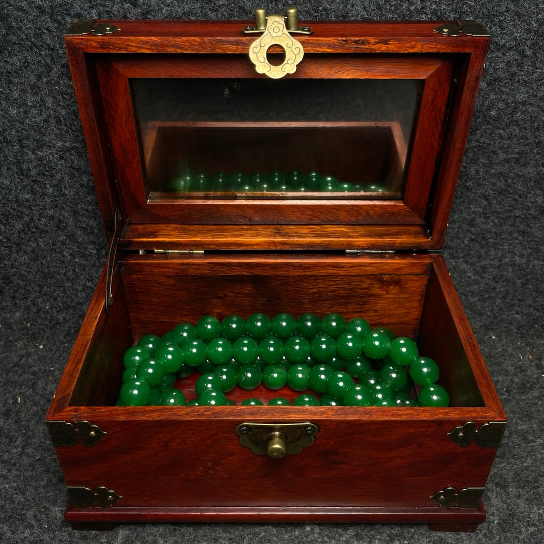A precious jade Buddhist prayer bead set inside a rosewood and gemstone-inlaid box. (1 of 9)