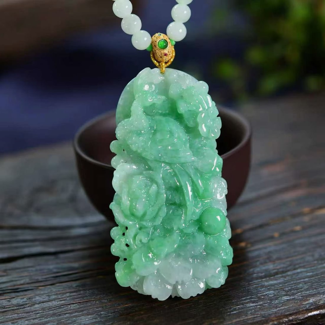 A peacock pendant carved from a bright green jadeite, adorned with a natural jadeite and silver: peacock pendant carved from a vibrant green jadeite, featuring exquisite carving and exceptional clarity. Its lustrous and translucent texture symbolizes wealth and fulfillment. Adorned with a