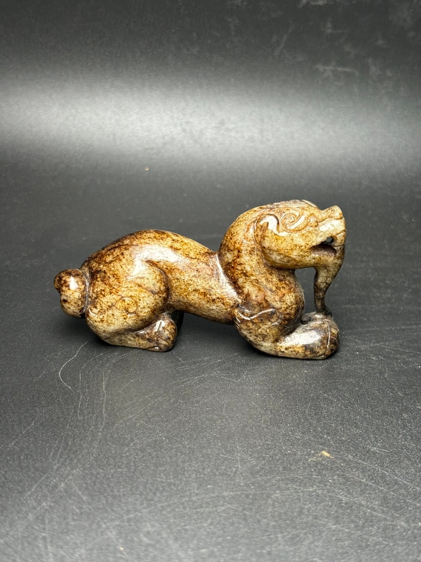 Hotan Jade Beast: Exquisite Hetian jade beast, symbolizing longevity, warding off evil, dispelling disasters, and bringing blessings. Beautifully carved, with a warm, lustrous texture and a rich, aged patina. Dimension