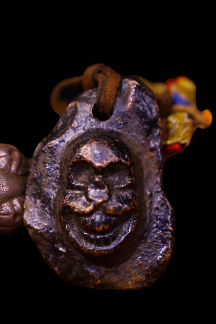 Copper-bodied, hand-hammered and engraved Buddha amulets: This copper-bodied, hand-hammered and engraved Buddha amulet measures 5 cm in height, 3.5 cm in width, and weighs approximately 118 g. Provenance:Private collection from a professor in Newcastle