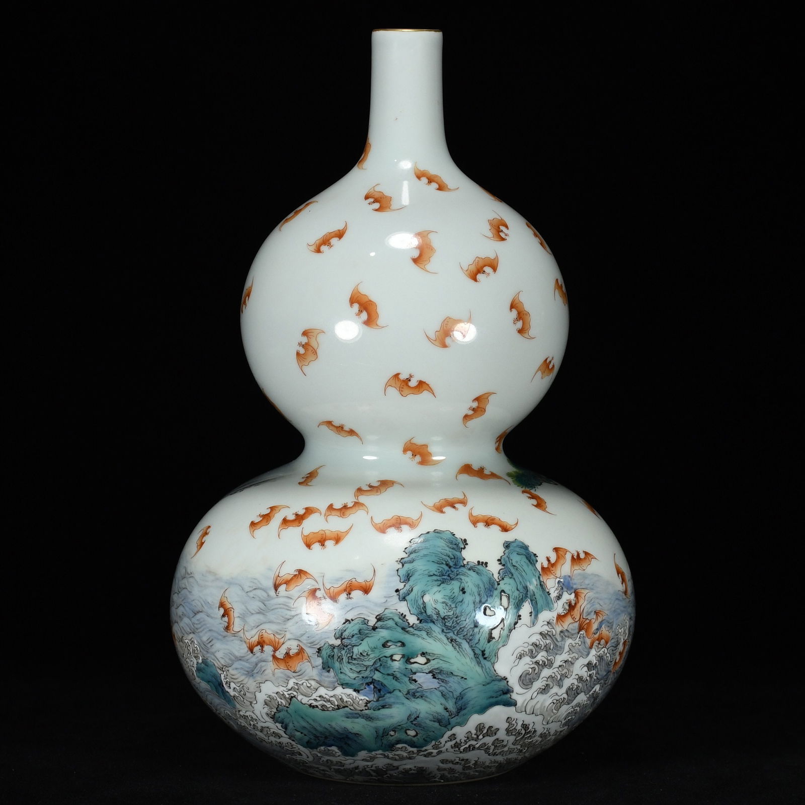 A famille rose gilt gourd-shaped vase with the inscription "May your fortune be as boundless as the: A famille rose and gilt gourd-shaped vase, made during the Qianlong reign of the Qing Dynasty, with the inscription "May your fortune be as boundless as the Eastern Sea and your longevity as enduring