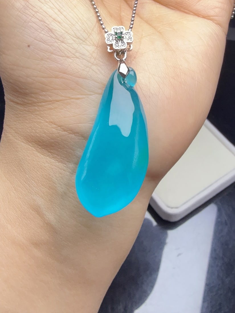 Jadeite of icy blue-green variety, resembling a "lucky gourd".: This jadeite "lucky gourd" piece, made of icy blue water, is lustrous and translucent, exquisitely three-dimensional, thick and full, and perfectly flawless. Provenance:from the collection of George S