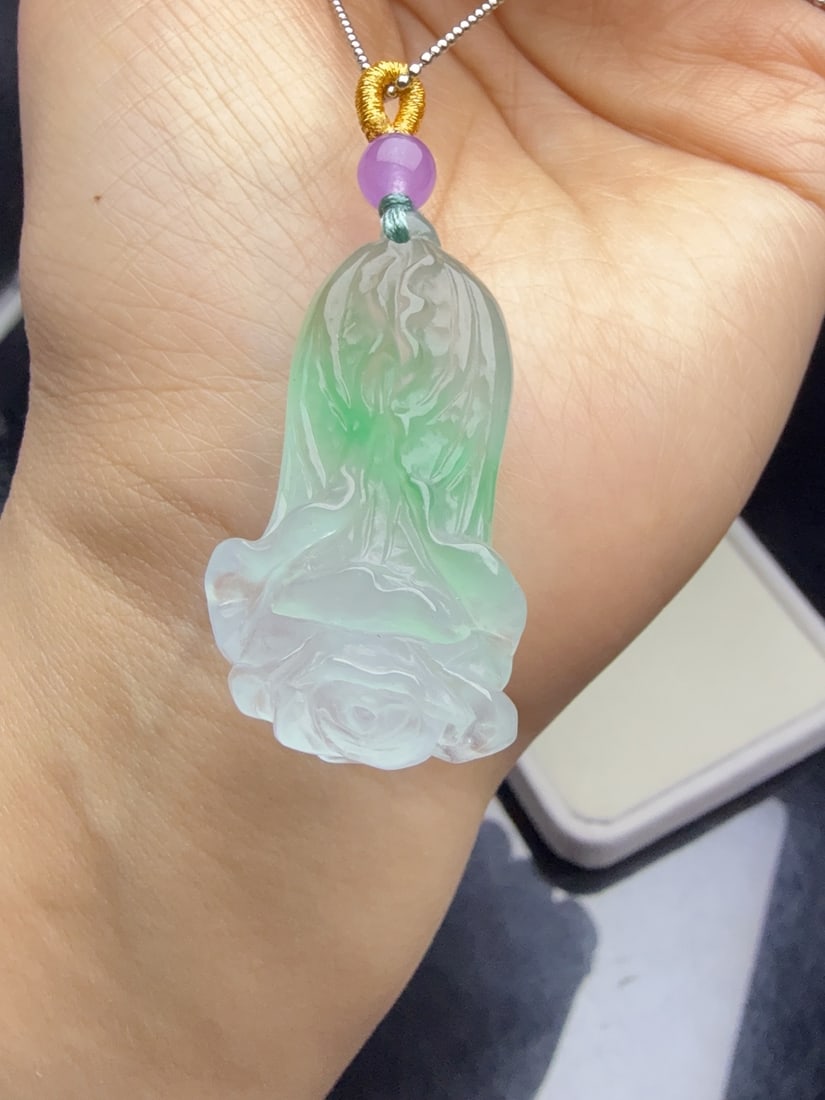A jadeite cabbage with icy green inclusions symbolizes "abundant wealth.": This jadeite cabbage, made of icy green with floating green hues, symbolizes "abundant wealth." It is lustrous and translucent, exquisitely three-dimensional, thick and full, and flawlessly free of cr