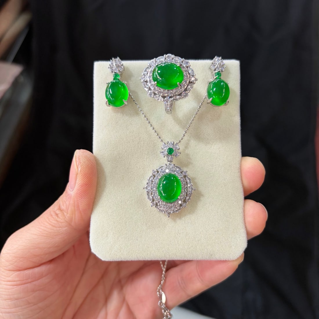 A luxurious jadeite set, featuring a full green icy hue and set with diamonds. (925 grade): This is a luxurious jadeite set, featuring a full green 925 grade jadeite with diamond accents. The jadeite itself is translucent and lustrous, exquisitely three-dimensional, perfectly round and full,