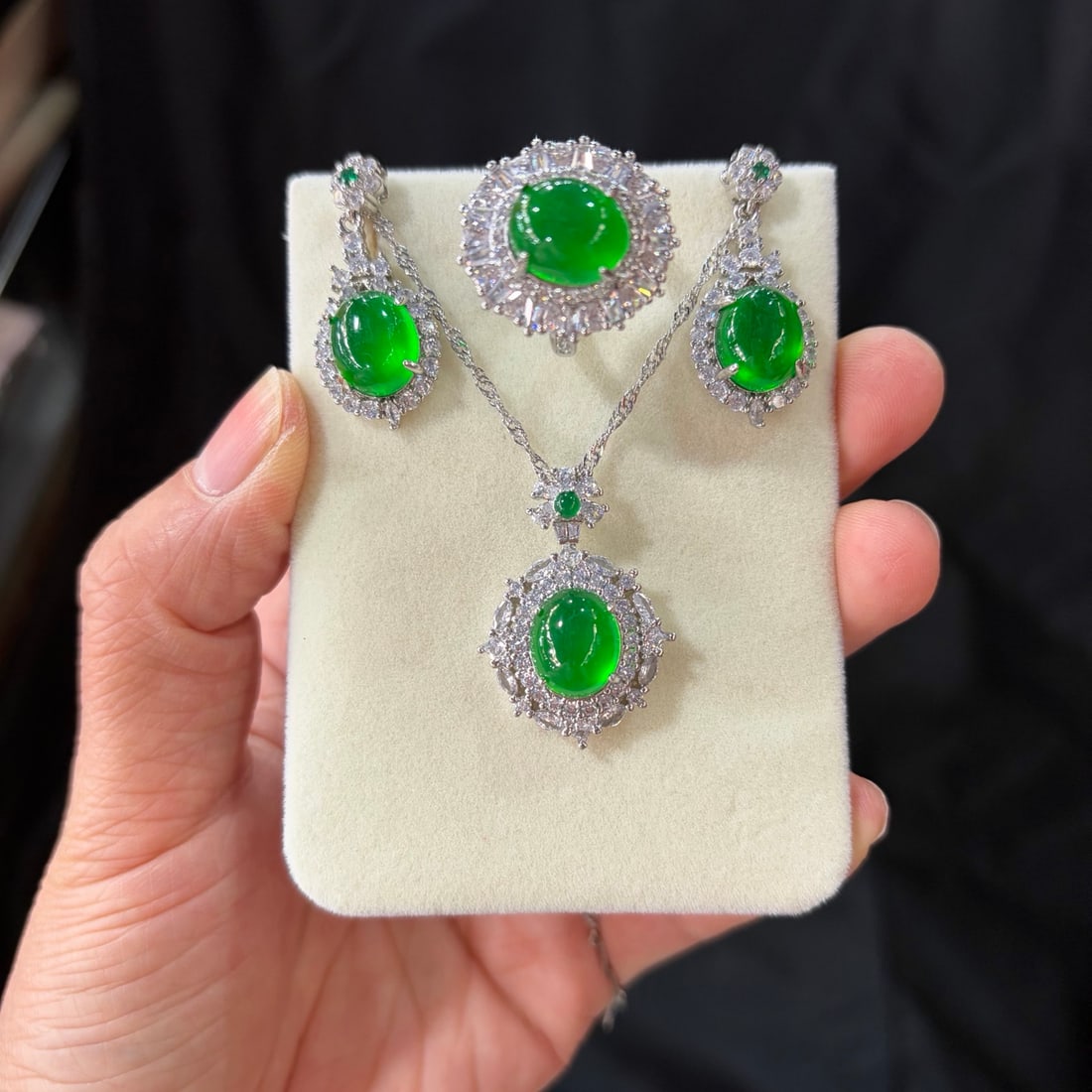 A luxurious jadeite set, featuring a full green icy hue and set with diamonds. (925 grade): This is a luxurious jadeite set, featuring a full green 925 grade jadeite with diamond accents. The jadeite itself is translucent and lustrous, exquisitely three-dimensional, perfectly round and full,