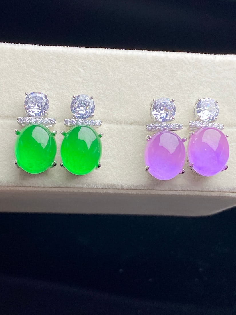 Jadeite Tricolor "God of Wealth": The jadeite earrings are of icy green quality, with a smooth and translucent appearance, exquisite and three-dimensional design, and flawless without any cracks. Provenance:from the collection of Geor