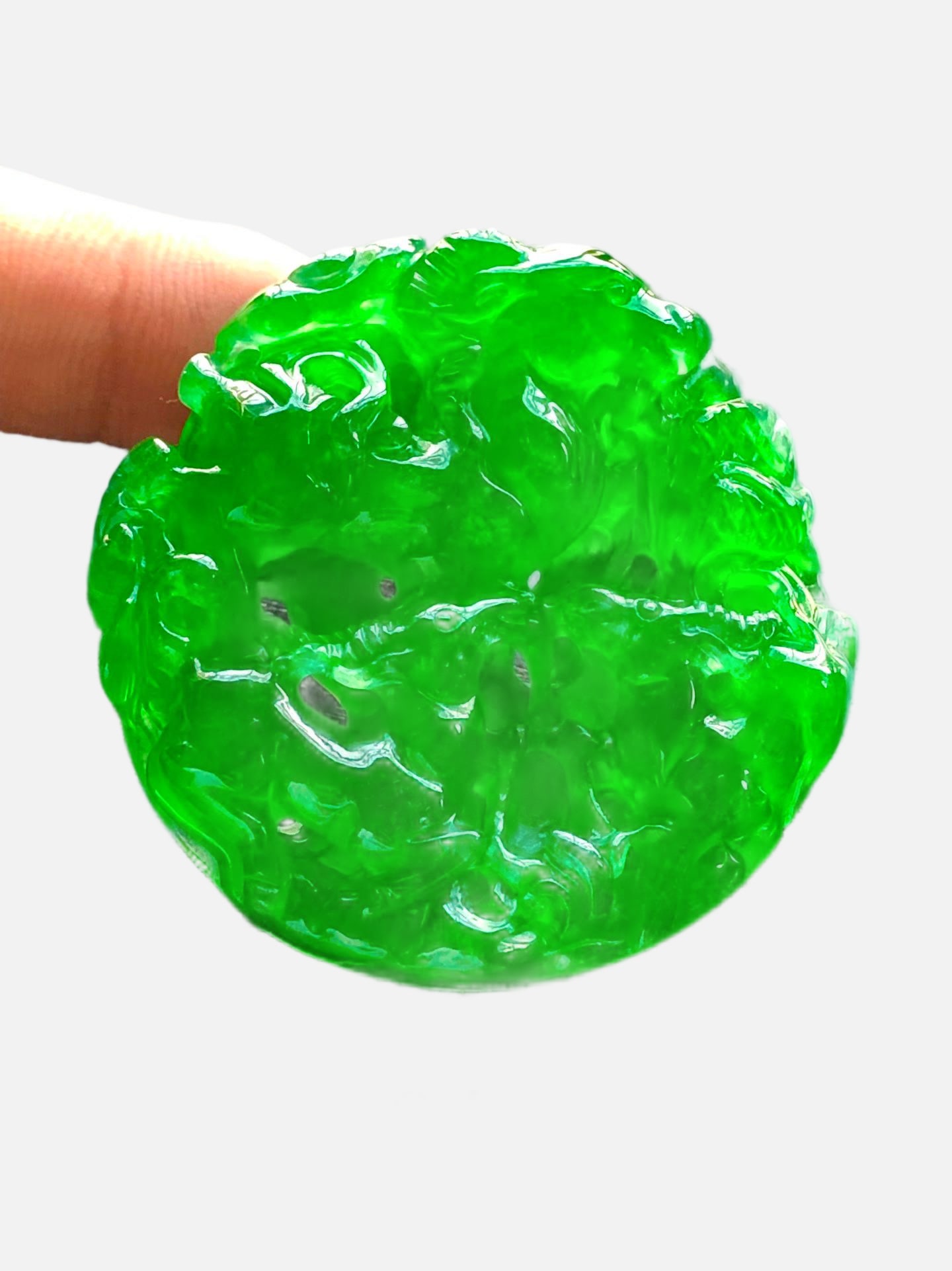 Imperial Green High-Ice Jadeite Double-Sided Hollow Round Pendant: Imperial green high-ice jadeite double-sided openwork round pendant, entirely handmade with exquisite openwork carving, beautiful color, oily patina, elegant to wear, in perfect condition. Provenance: