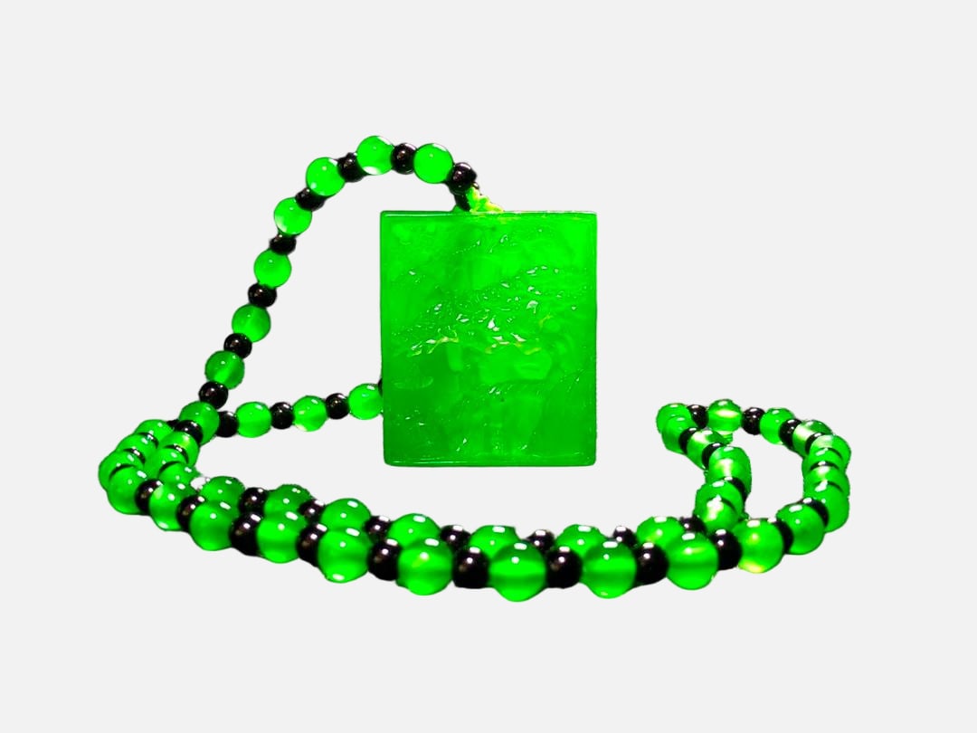 Imperial Green High-Ice Jadeite Landscape Pendant Necklace: This imperial green, high-quality icy jadeite landscape pendant necklace is made from superior material. It is icy and translucent, with a full green color and a beautifully carved landscape pattern.