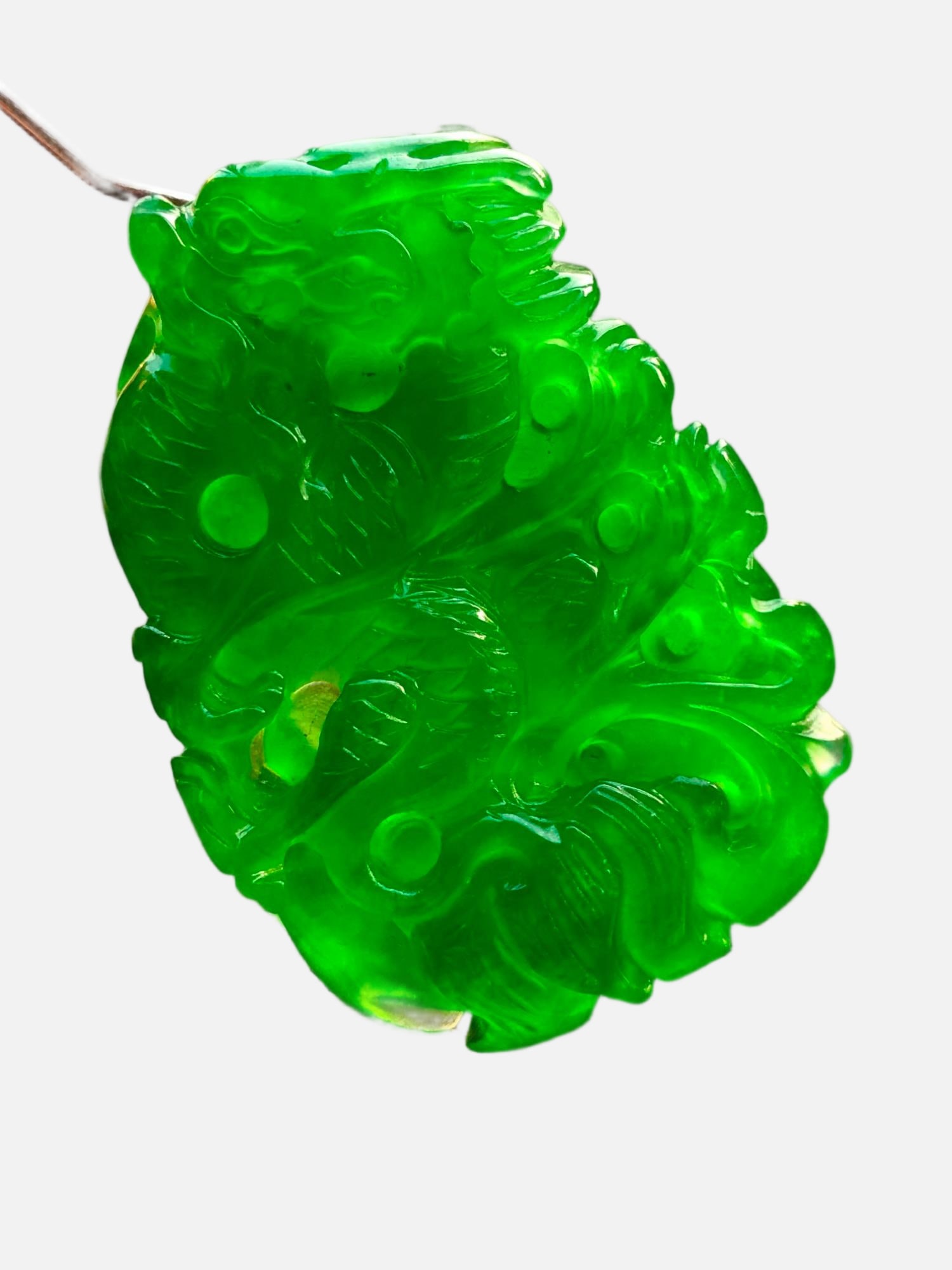 Imperial Green High-Ice Jadeite Ruyi Dragon Pattern Pendant: This imperial green, high-quality icy jadeite pendant with a dragon design is made from the finest material. It is icy, translucent, and lustrous, featuring a three-dimensional carving, beautiful colo