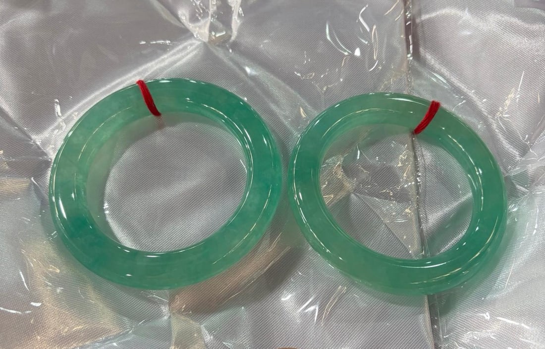 A pair of icy blue round jadeite bracelets: A pair of icy blue round jadeite bracelets Provenance:Private collection, Manchester, The United Kingdom. Our cooperative logistics services provider expertly handles both domestic and global