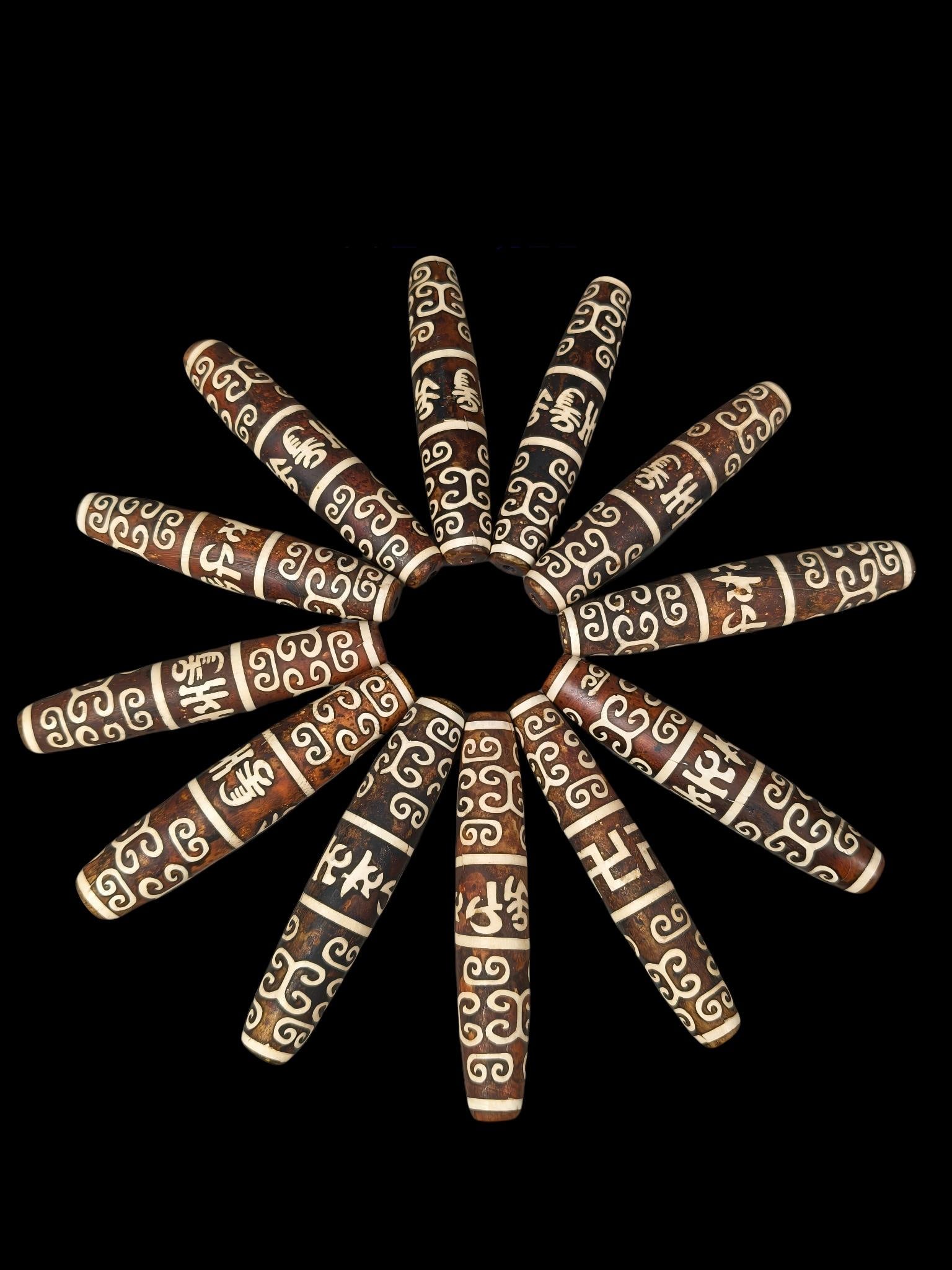 Twelve heirloom agate dzi beads: These are 12 rare, heirloom-quality agate dzi beads, each with a rich, natural patina and perfectly preserved condition. They are 10cm long, 2.2-1.8cm in diameter, and weigh approximately 62-47g each.