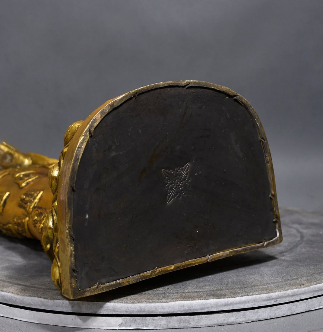 Tibetan Buddhist bronze Buddha statue, Shakyamuni, with a thick, elegant body, a golden finish, and: This Tibetan Buddhist bronze statue of Shakyamuni is thick and heavy, with an elegant color and a golden body. The face is round and round, exuding a simple and dignified air. It is a rare collectible