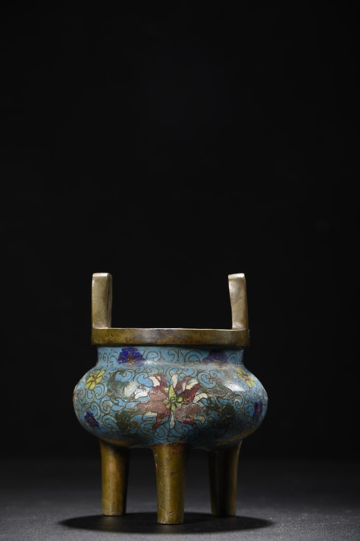 Cloisonne enamel incense burner with lotus scroll design on a copper body and pointed handles.: A cloisonne enamel incense burner with lotus scroll design on a copper body, 14cm high, 7.5cm in diameter at the mouth, and weighing 1245g. Provenance:from the collection of George Stopher, Kent, purc